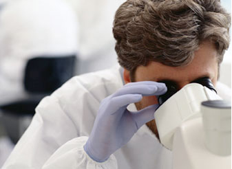 Scientist using a microscope